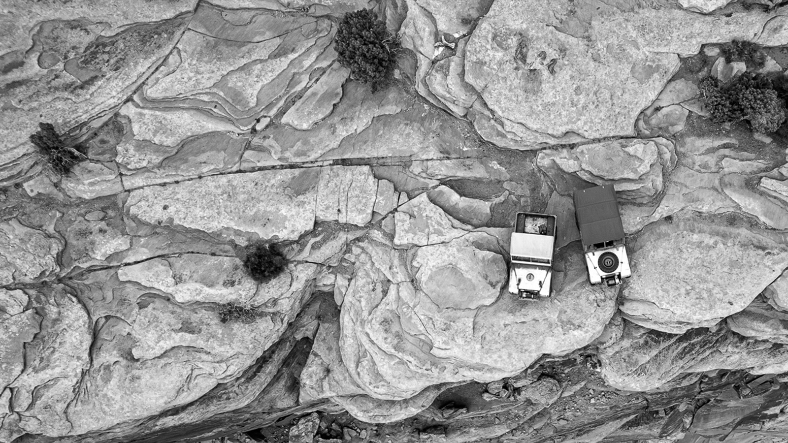 aerial photo of two Series 1 Land Rovers on a rocky mesa